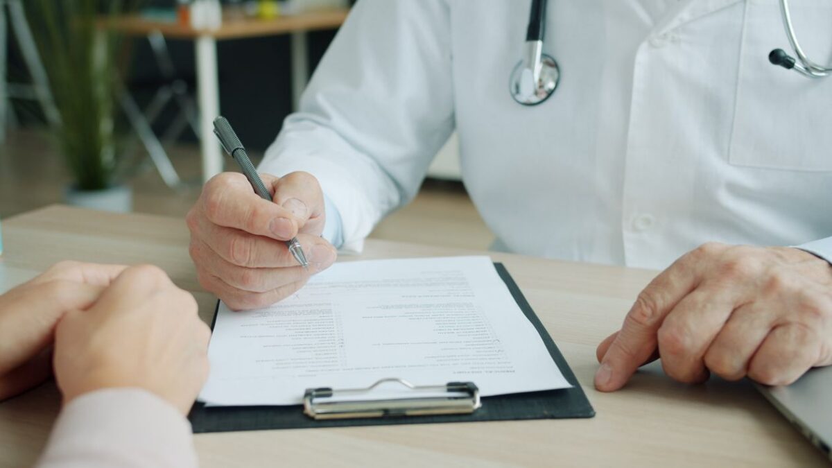 Doctor and patient reviewing medical documents during a consultation